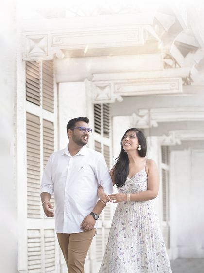 A bright and airy pre-wedding photo of a couple walking together. This high-key style creates a fresh, dreamy, and optimistic feel.