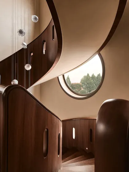 This sculptural, free-flowing wooden staircase is the heart of our Embassy 821 project in Bangalore. We designed it not just for passage, but as a piece of functional art, with cascading glass pendants that create a dynamic play of light and shadow, embodying our belief in modern organic luxury.