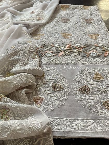 A full view of the laid-out suit, emphasizing its unique color palette and intricate craftsmanship.