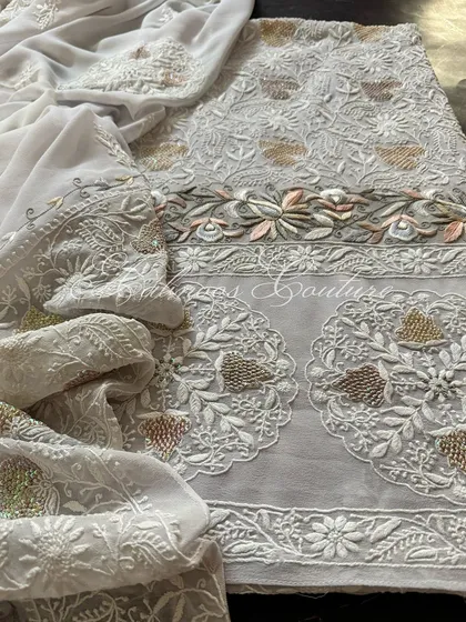 A full view of the laid-out suit, emphasizing its unique color palette and intricate craftsmanship.