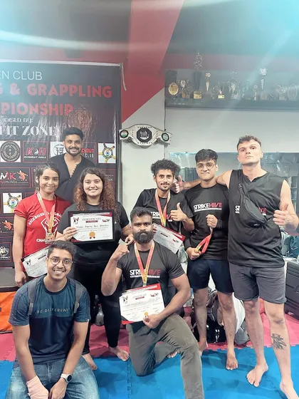 The winning team. Our students and coaches celebrate their success at the open kickboxing championship.