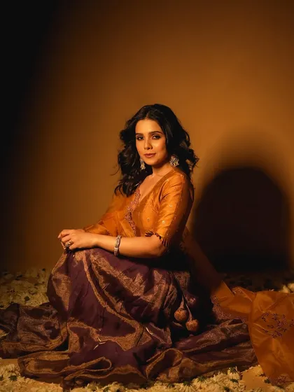 A full-length view of the look for Rashmi Agdekar. The makeup is designed to look beautiful from a distance and in person, not just in close-ups.