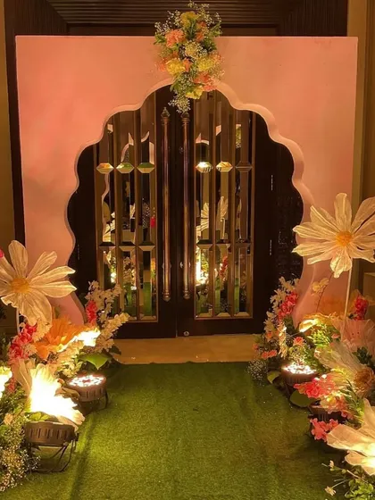 We believe the magic starts at the entrance. For this cradle ceremony, we created an enchanting garden-themed entryway with a custom arch, a green turf walkway, and oversized paper flowers to welcome guests into a world of celebration.