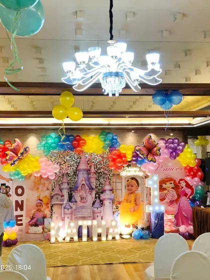 A wide shot of the venue for the princess-themed first birthday, showing how the stage decoration becomes the centerpiece of the entire hall.