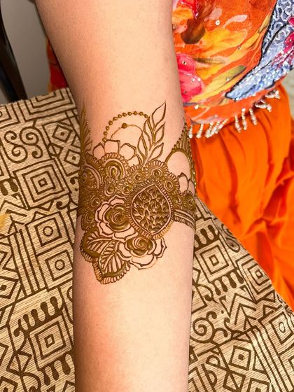 A beautiful armband design featuring intricate floral and leaf patterns. This is a great option for someone who wants a smaller, yet detailed design.