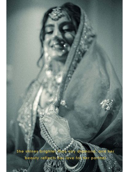 An artistic, blurry black and white shot of Vanaja, her smile shining through, capturing a moment of pure, uninhibited joy.