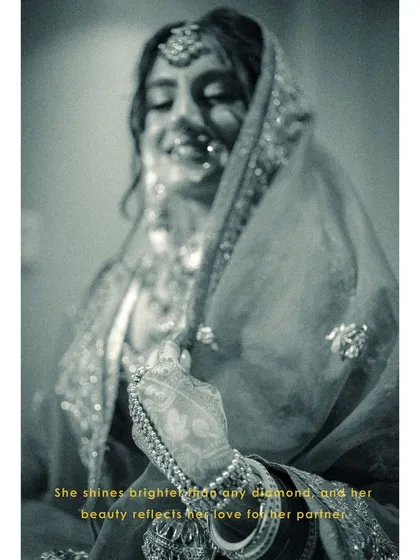 An artistic, blurry black and white shot of Vanaja, her smile shining through, capturing a moment of pure, uninhibited joy.