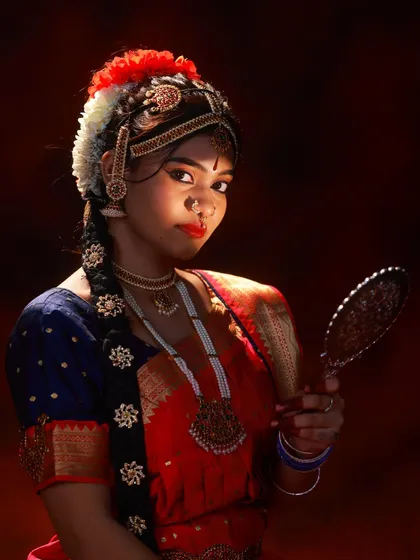 I love capturing the details. This close up highlights the abhinaya, or facial expression, which is the soul of classical dance. The lighting focuses on the intricate temple jewellery and traditional hair styling.