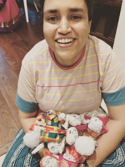 Holding an armful of handmade dolls from our workshop. Each one represents a story and a moment of healing. This is the joy that comes from reconnecting with our inner child.