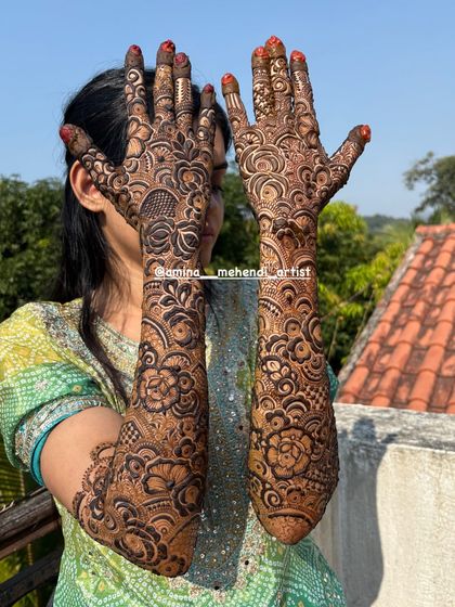 A beautiful shot with a natural background, highlighting the organic feel of the henna art. This design is dense and detailed, perfect for a bride.