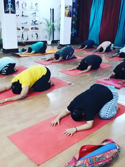 A moment of surrender in Shasankasana (Child's Pose). This gentle resting pose is used between more challenging asanas to help students reconnect with their breath and conserve energy.