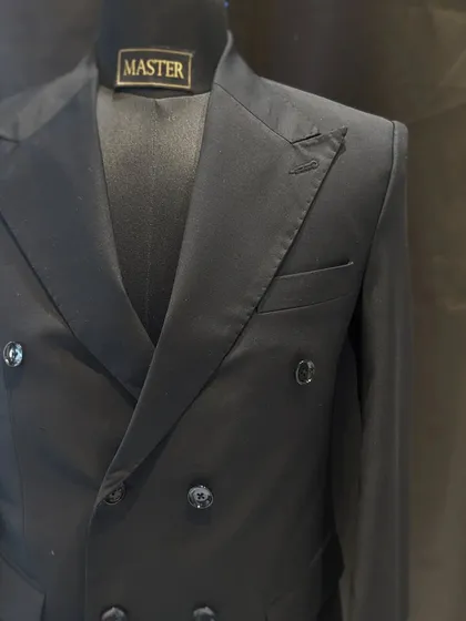 A classic black double-breasted suit is a must-have in any gentleman's wardrobe. I focus on sharp tailoring and peak lapels to create a powerful and timeless silhouette.