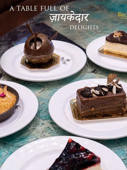 A table full of our delightful desserts. This image showcases the variety we offer, from traditional Kunafa to modern cheesecakes and pastries.