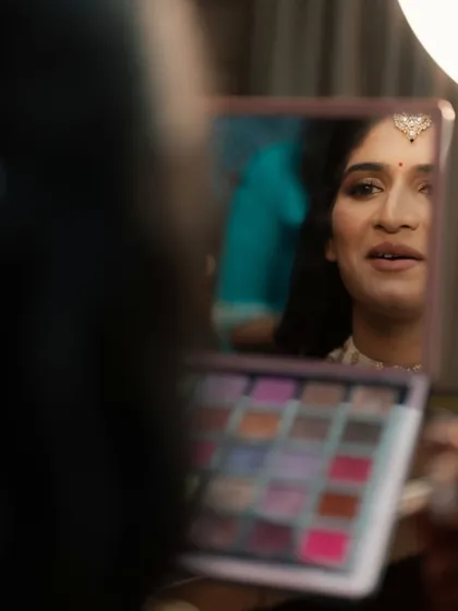 A candid moment of the bride checking her makeup in the mirror. Her satisfaction is my ultimate goal.