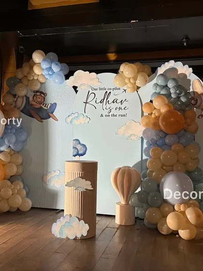 The main photo backdrop for the Aviator Bear theme, complete with a large light-up number one and a life-sized pilot teddy bear.