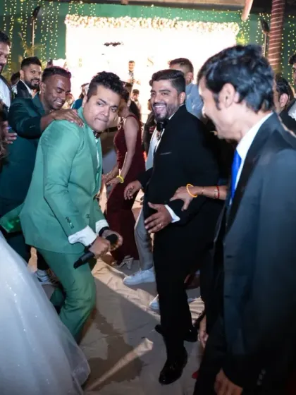 The emcee brings everyone together on the dance floor. Capturing these interactive moments shows the fun atmosphere of the wedding reception.