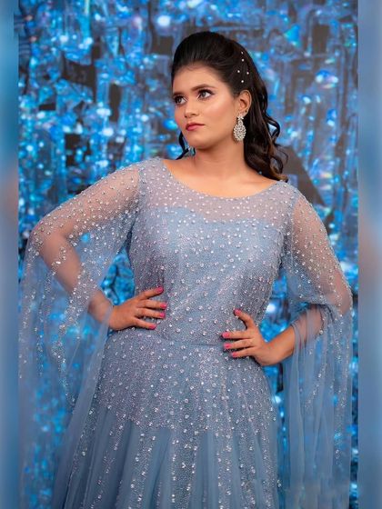 Blue is more than a color, it's a vibe. This sparkling powder blue gown with cape sleeves is perfect for a modern, stylish bride at her reception.