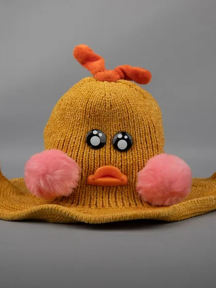 An angled shot of the mustard-yellow duck hat.