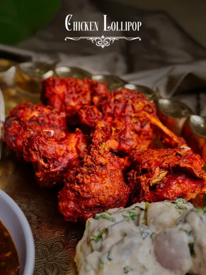 Crispy and succulent Chicken Lollipops, a star attraction of our Thaal-E-Cheen. They are fried to perfection and have a flavorful, spicy coating.