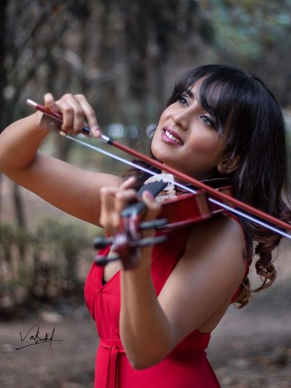 A close-up shot focusing on the connection between the musician and her instrument. The model's joyful expression as she plays adds a layer of soul and emotion to this conceptual portrait.
