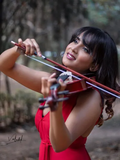Capturing the joy of making music in this shot from our conceptual violin shoot. The model's smile as she plays adds a layer of warmth and personality to the artistic theme.