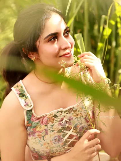 A close-up with a dreamy, sun-kissed feel. The bride looks up towards the light, her expression full of hope and happiness.