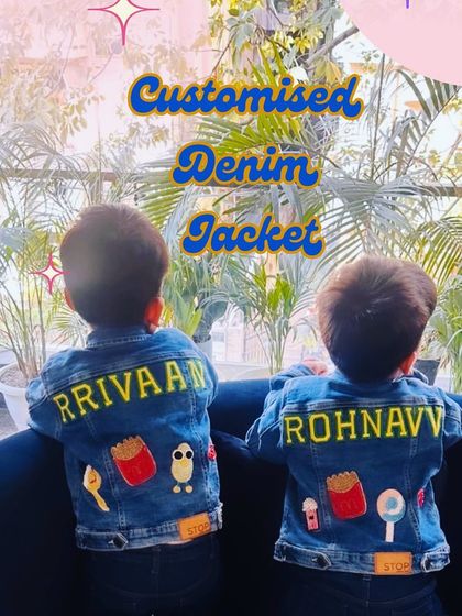 Two brothers, Rrivaan and Rohnavv, wearing their matching personalized denim jackets. Each jacket is customized with their name and a unique set of their favorite patches.