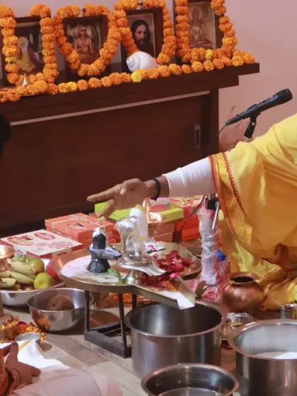 A priest offers guidance to a participant during a puja. These ceremonies are interactive, allowing everyone to feel personally connected to the ritual.