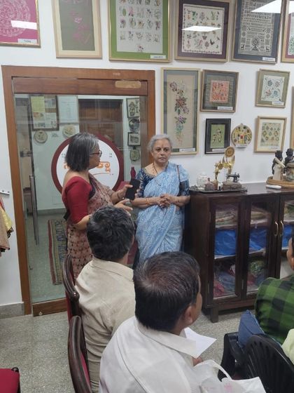 Explaining the nuances of different embroidery styles to visiting design students. Sharing knowledge and fostering creative discussions is a core part of my mission.