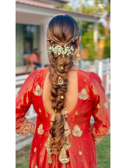 A beautiful messy braid adorned with baby's breath and traditional hair jewellery.