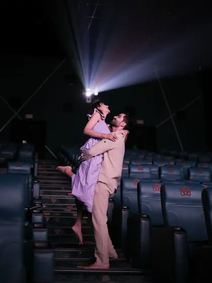 Your love story is the main feature. In this creative theatre photoshoot, I use the dramatic beam of a projector to create a unique, cinematic portrait that feels like a scene from a movie.