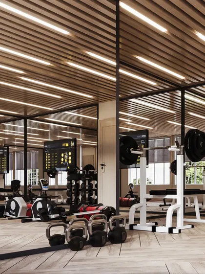 This view highlights the full range of equipment and the use of floor-to-ceiling mirrors to make the space feel larger and brighter.