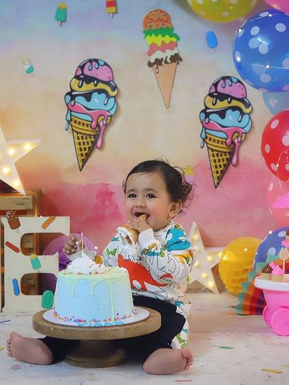 The best part of a cake smash is getting to eat the cake! This close-up shot captures the pure delight of his first taste of birthday cake.