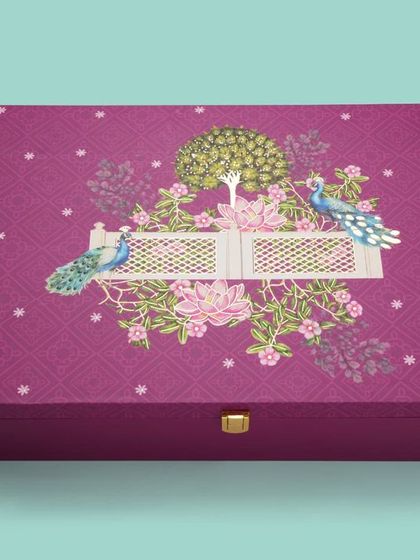 A premium, ornate purple gift box with a clasp, shot for a packaging catalogue. We highlight the unique features and high-quality details of the packaging.