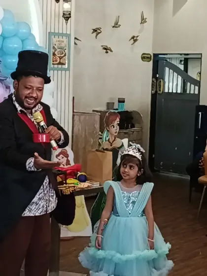 The birthday girl herself assisting the magician with a trick. We make sure the guest of honor feels extra special.