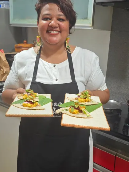 Here I am, holding plates of appetizers for my guests. Hosting people in my home and seeing them enjoy my food is what I love most about my work.