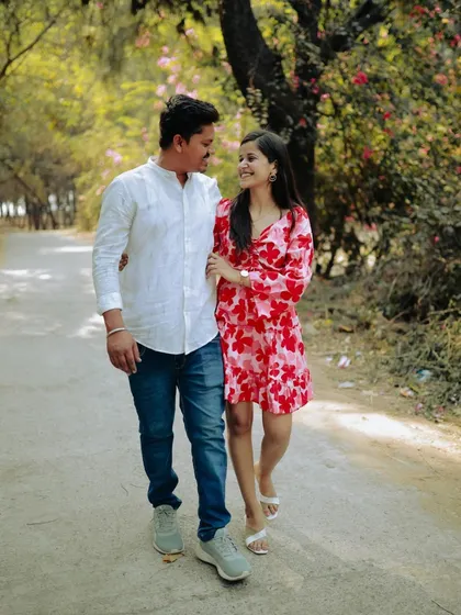 A happy walk down a tree-lined path. This candid shot captures a simple, joyful moment from their pre-wedding day.