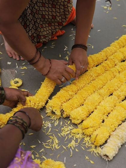 Our team preparing flower garlands for the SwarTaal festival.