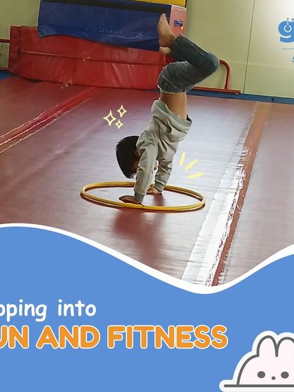 Flipping into fun and fitness. This young boy masters a handstand within a hoop, a creative challenge that improves precision, strength, and focus.