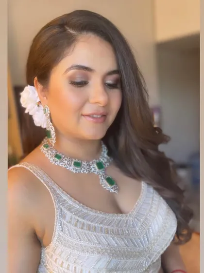 A close-up of the fresh, floral-accented hairstyle.