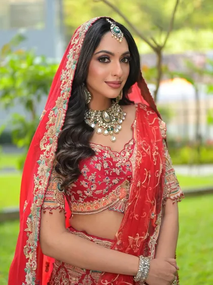 A confident portrait of my signature bridal look. The makeup is balanced to complement the heavy jewellery and intricate embroidery of the lehenga.
