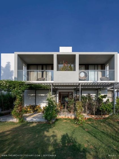 The full front elevation of the SAMAM House, as featured in The Architect's Diary. The design shows a clear distinction between the solid private volumes and the lighter, more open public spaces.