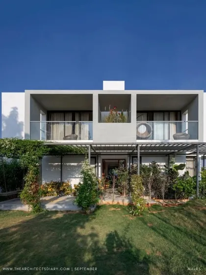 The full front elevation of the SAMAM House, as featured in The Architect's Diary. The design shows a clear distinction between the solid private volumes and the lighter, more open public spaces.