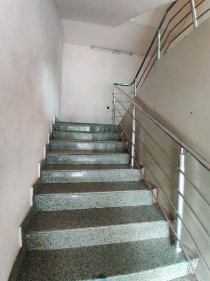 A plain staircase, the blank canvas for our vibrant and artistic intervention.