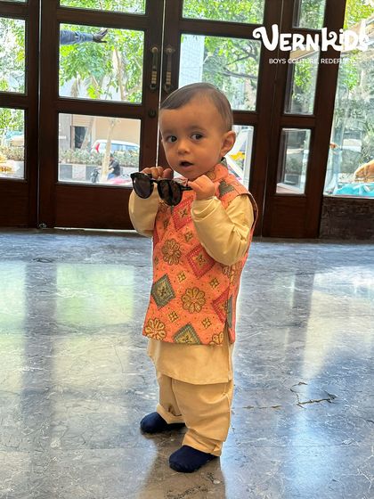 Another shot of our little NRI client looking cool and confident in his peach Bundi set, complete with sunglasses.