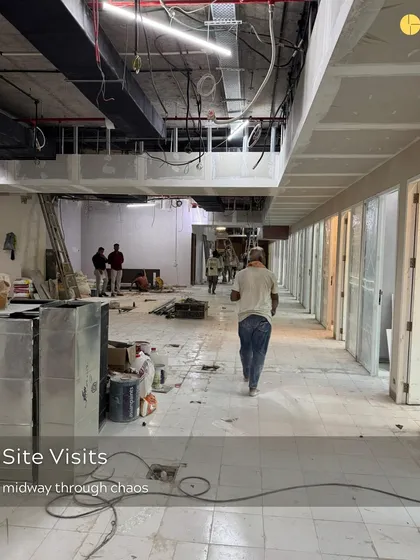 Midway through the chaos of a site visit. This is where the real work happens, amidst the dust and materials, as a raw construction site slowly begins to take the shape of a designed space.