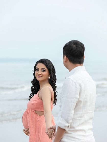 A beautiful "follow me to" style shot on the beach, capturing her joyful expression as she leads her partner.