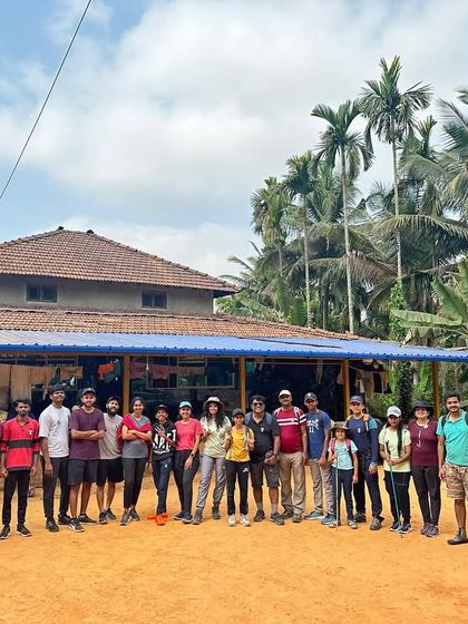The group standing in front of a local eatery or homestay, ready for a good meal after a long trek.