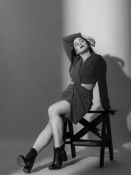 A striking black and white portrait that emphasizes the shapes and shadows of this bold, confident look.