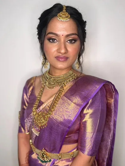 This portrait captures the bride's serene expression. The makeup is perfectly balanced, with defined eyes and a soft lip, allowing her natural beauty to be the focus.